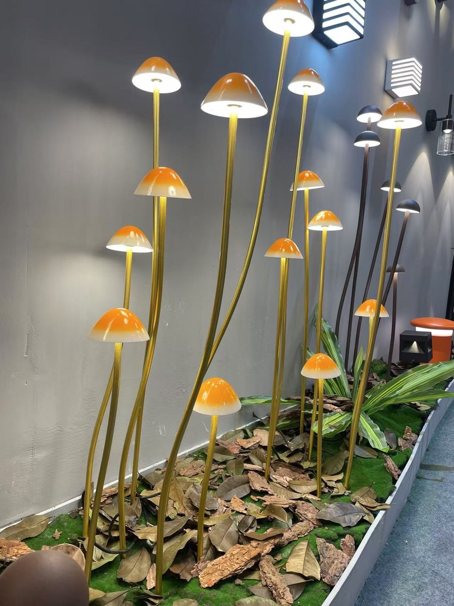 Mushroom spike lights — the domed shade holds the light down on the ground cover